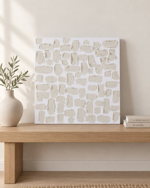 Square canvas of thick cream plaster blocks, resting on an oak bench